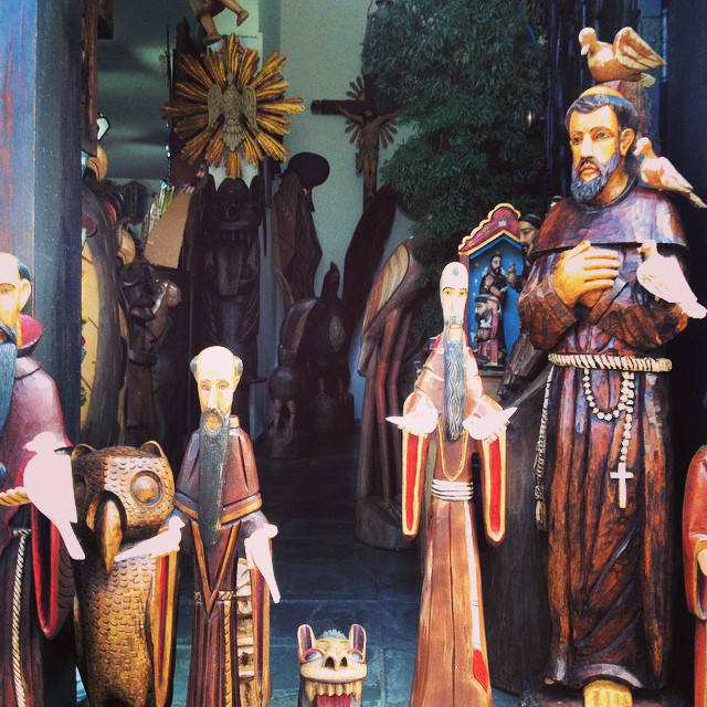 several colorfully painted statues and statues of figures