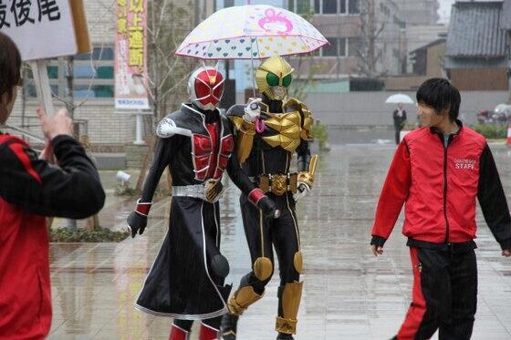 two people in ninja suits walking down the street