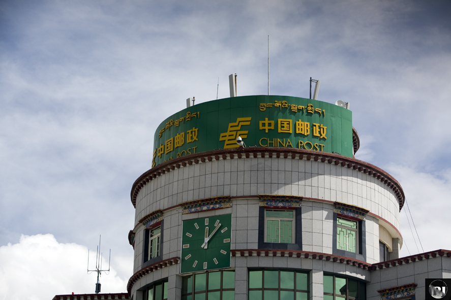 a round building with a clock on the side of it