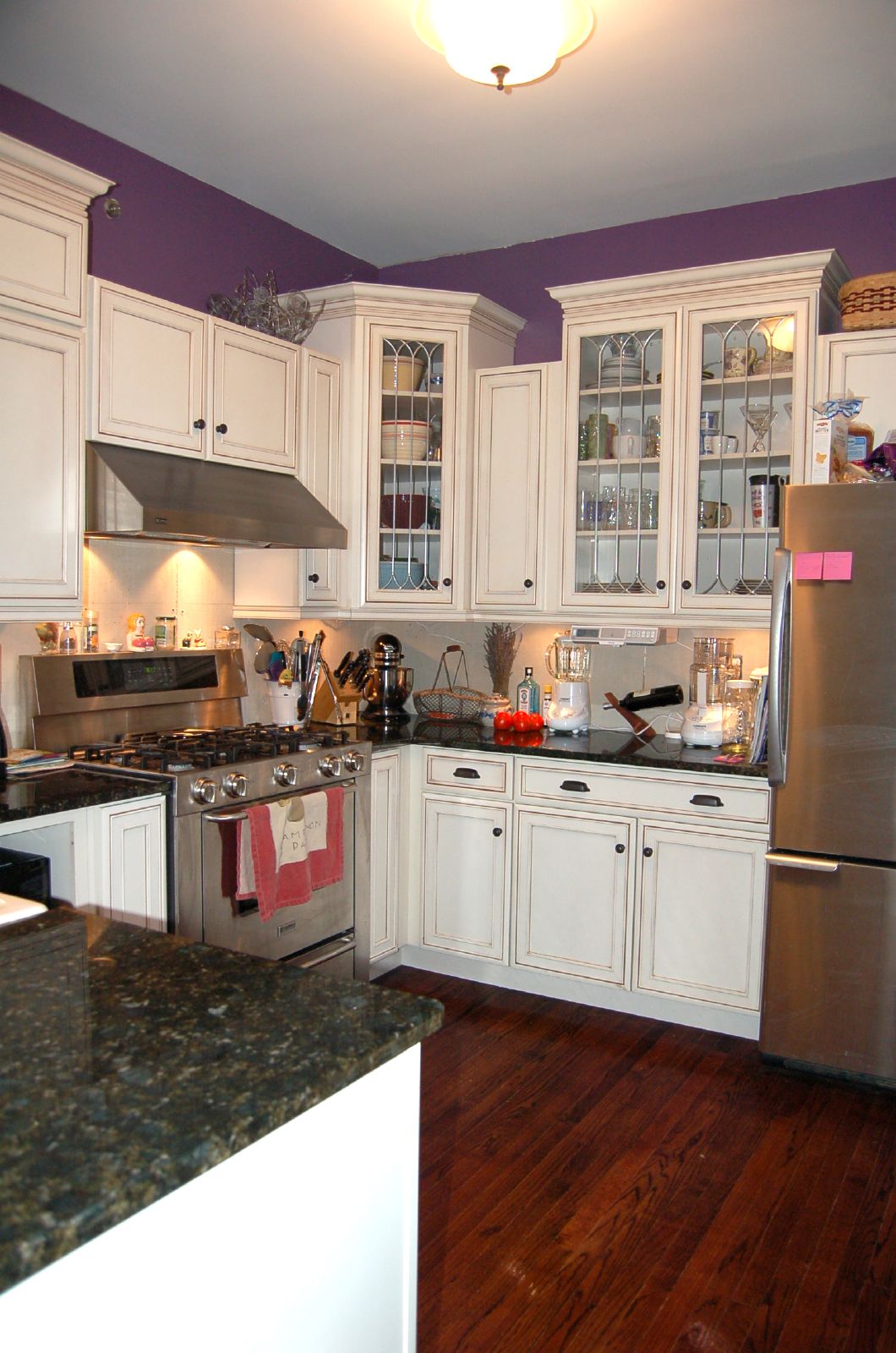 a kitchen is furnished with cabinets and a refrigerator