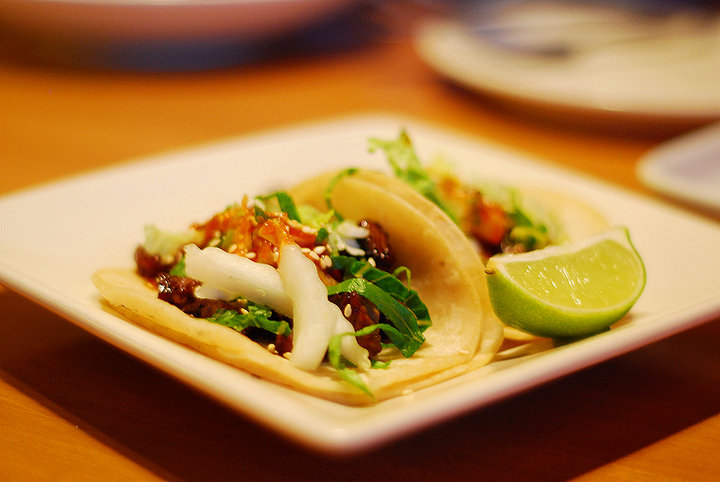 some tacos are on a plate on a table