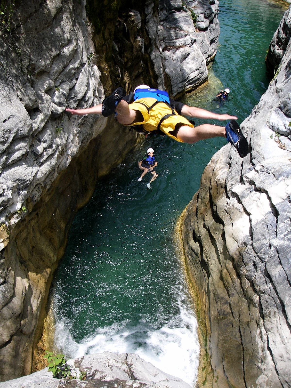 a man standing on his stomach as he rides an upside down raft