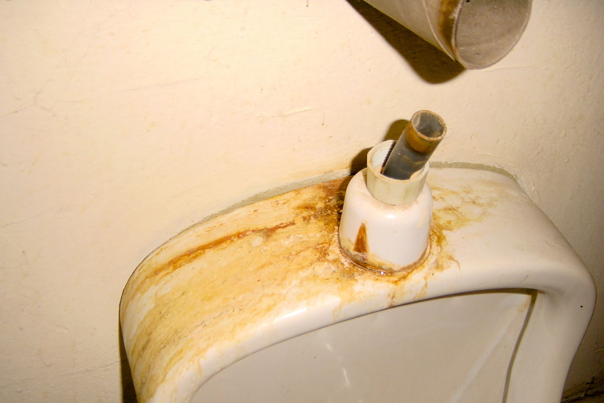 some rust stains all over a nasty bathroom toilet