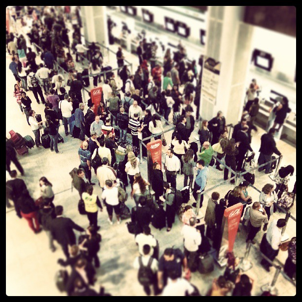 many people waiting in the lobby at a airport