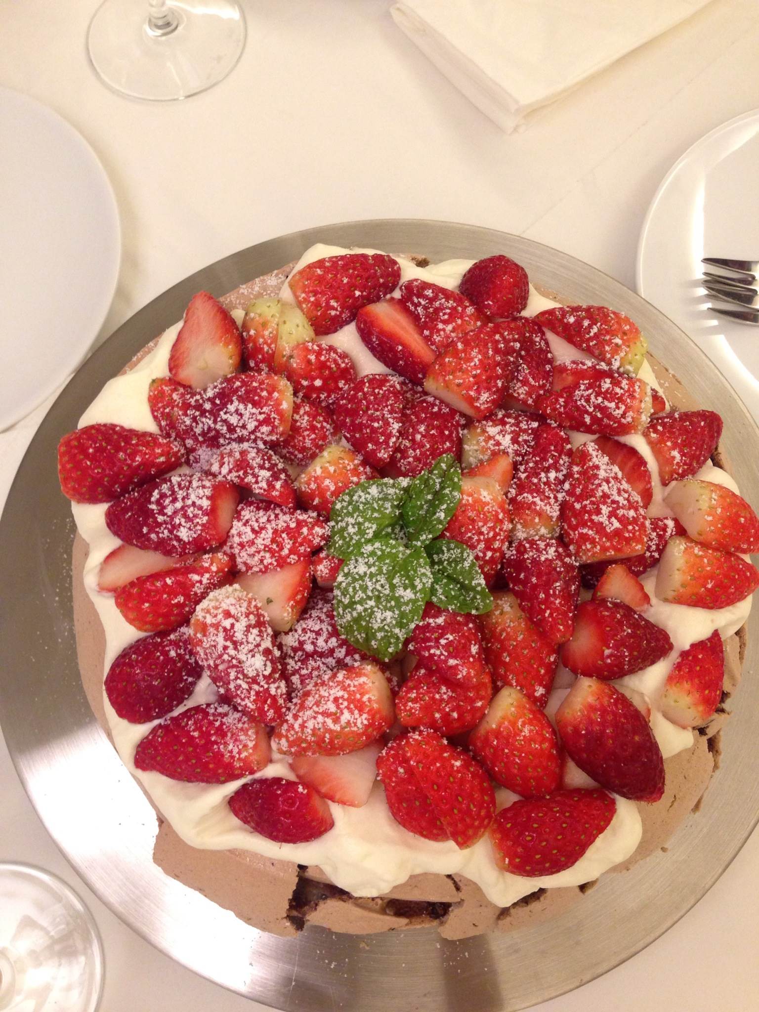 a dessert is decorated with sugar and cut strawberries