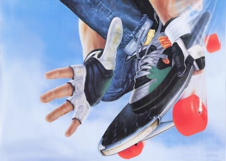 a hand with a shoe on a skateboard