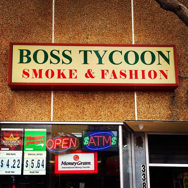 a sign above the door says boss tycon smoke and fashion