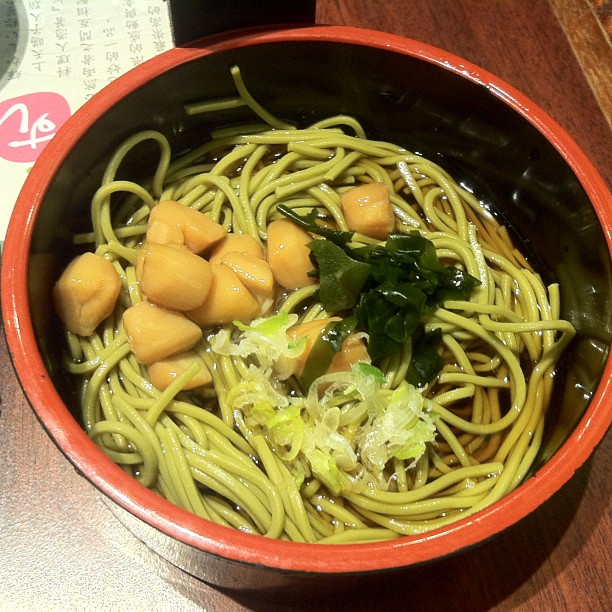 a bowl filled with pasta topped with sea urchin