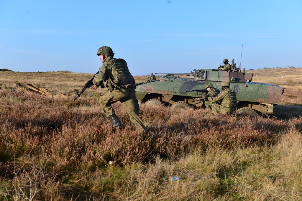 two soldiers in camouflage in the field