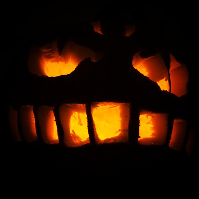 a carved pumpkin with several hands in it