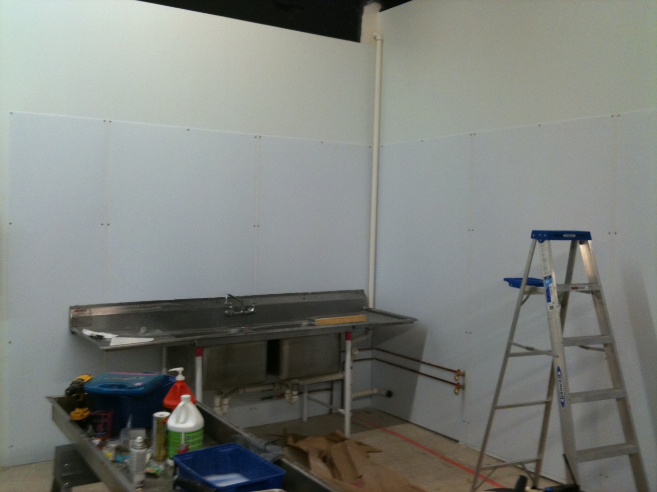 there is a kitchen that has the paint being applied