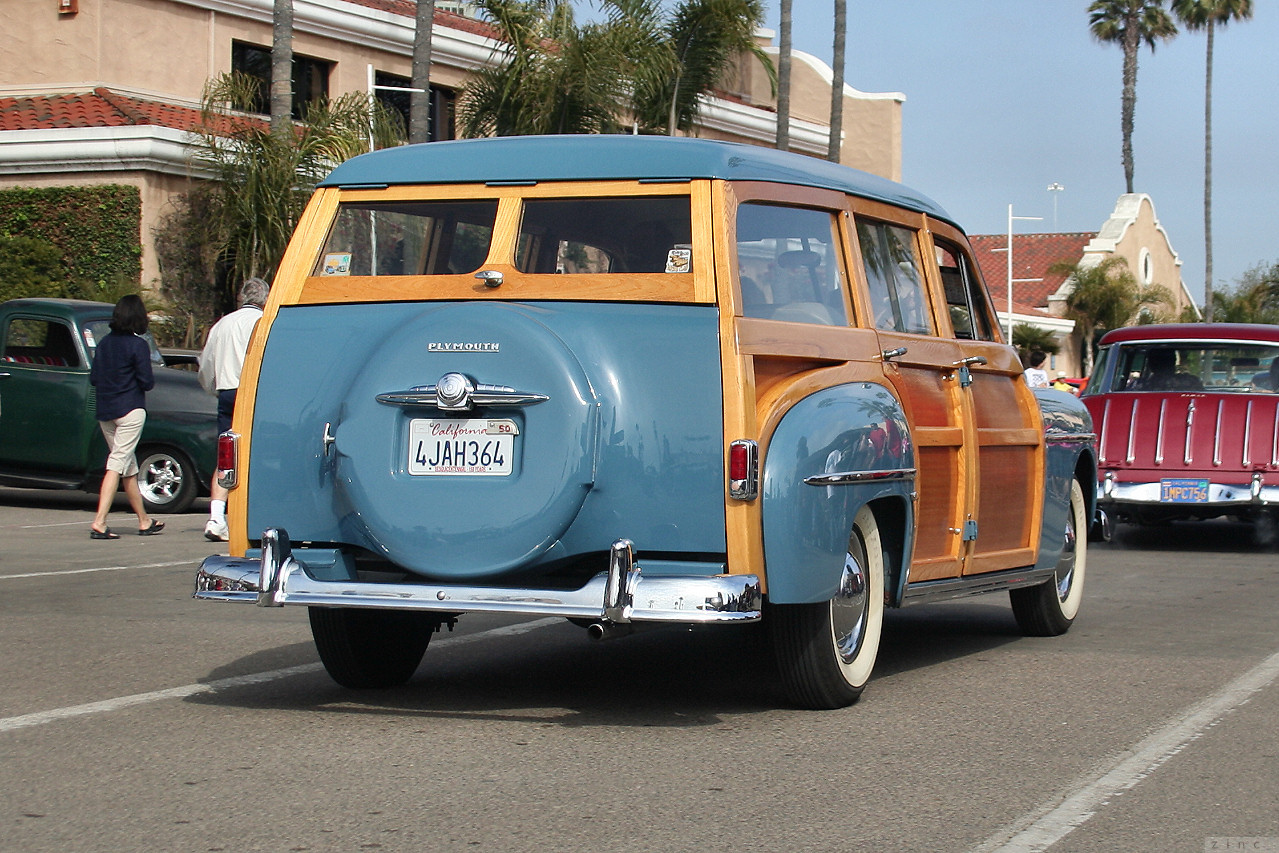 an old blue and orange car with wooden doors