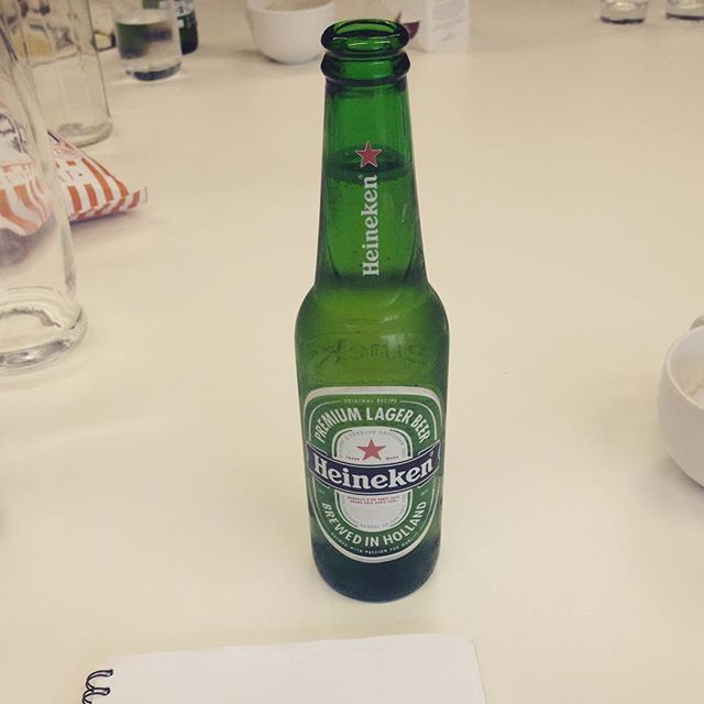 a green beer sitting on top of a table