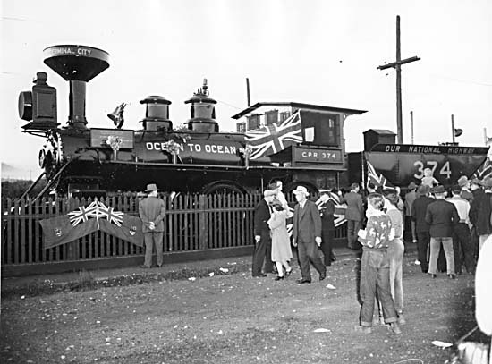 a group of people standing in front of a train on tracks