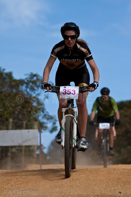 man in black biking on dirt trail during race