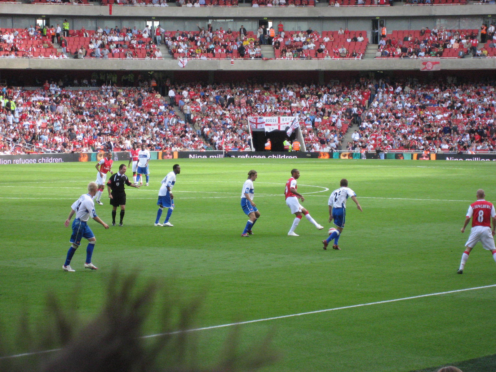 a group of soccer players standing on a soccer field