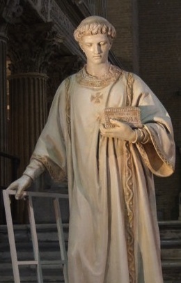 a statue of a person standing next to a railing