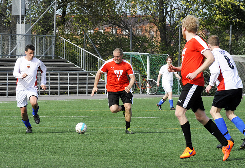 several men are playing soccer on a field