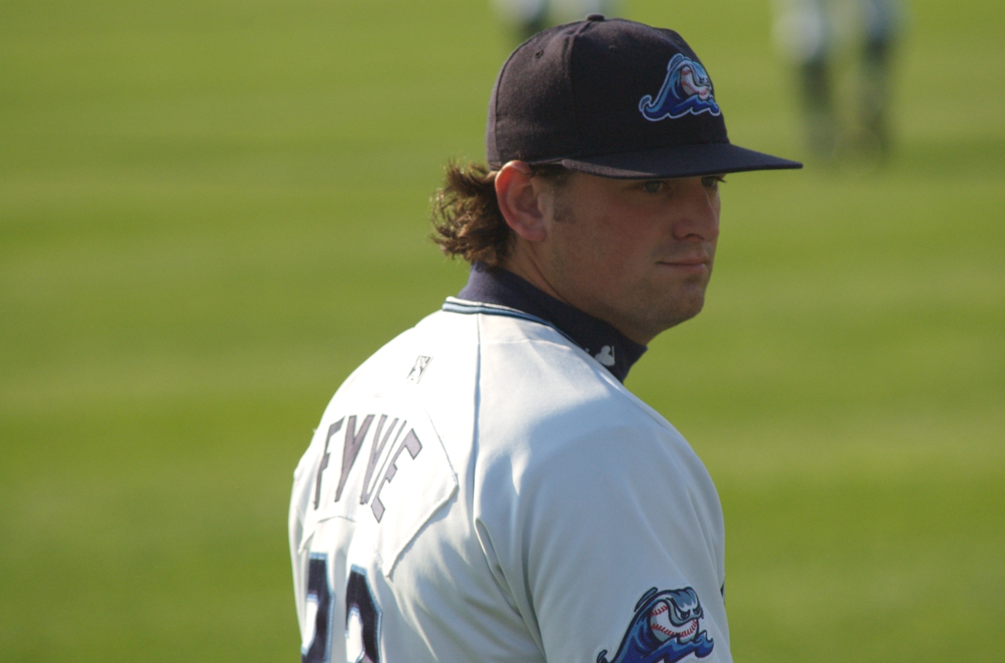 a baseball player wearing a hat and a jersey