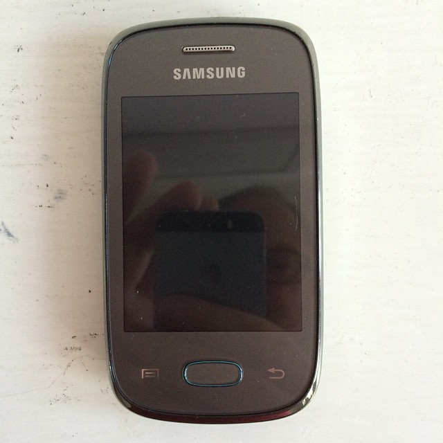 the samsung cell phone is laying on the table