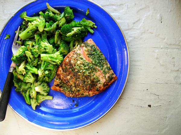 a plate of food with broccoli and fish on it