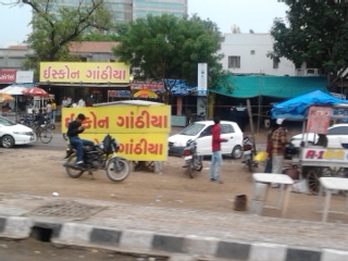 an indian language sign sitting on the side of a road