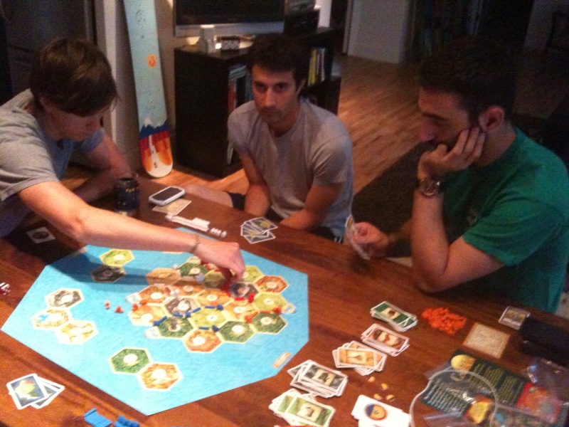 a group of men at a table playing with an old game