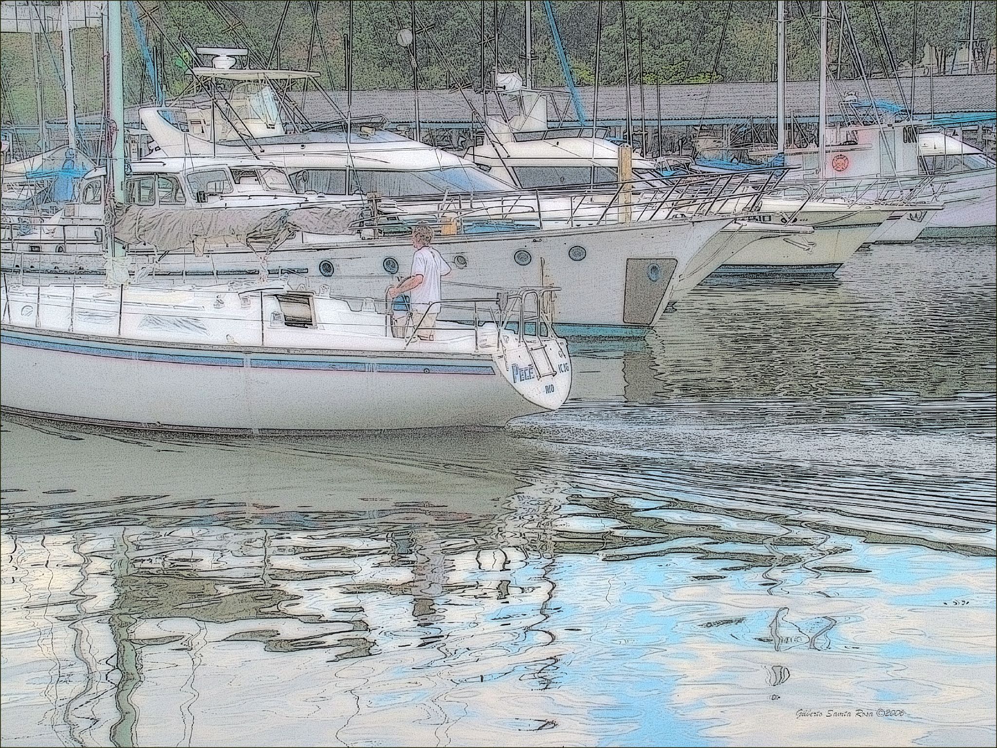 a group of sailboats are parked along the dock