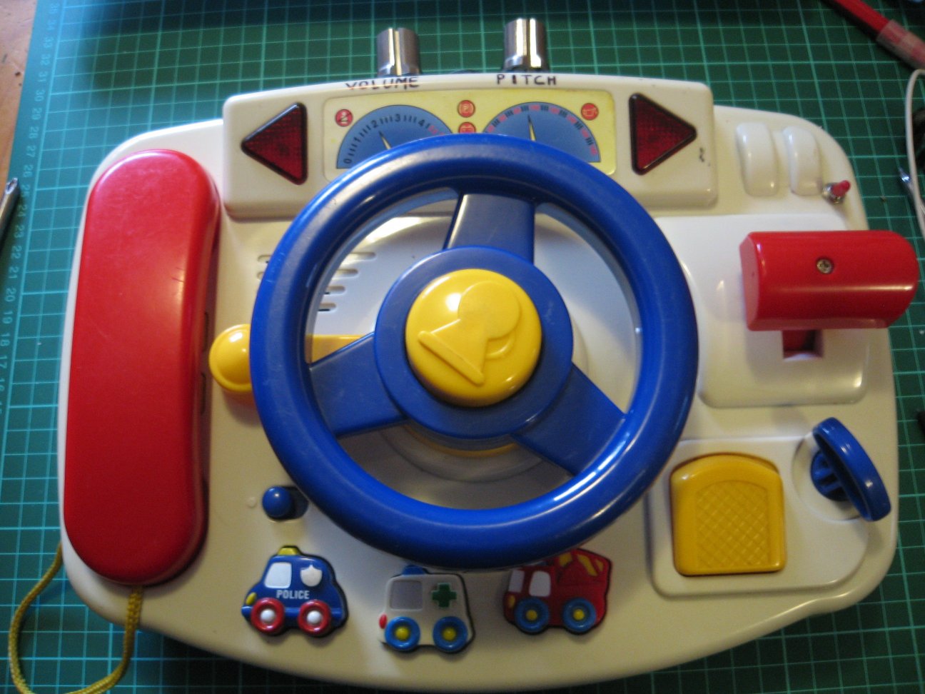 a toy childs activity vehicle sitting on top of a desk