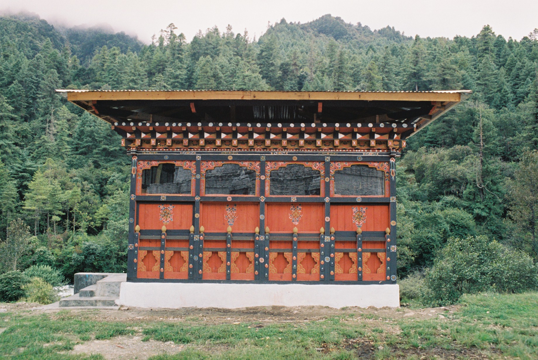 an oriental style covered building in a forested area