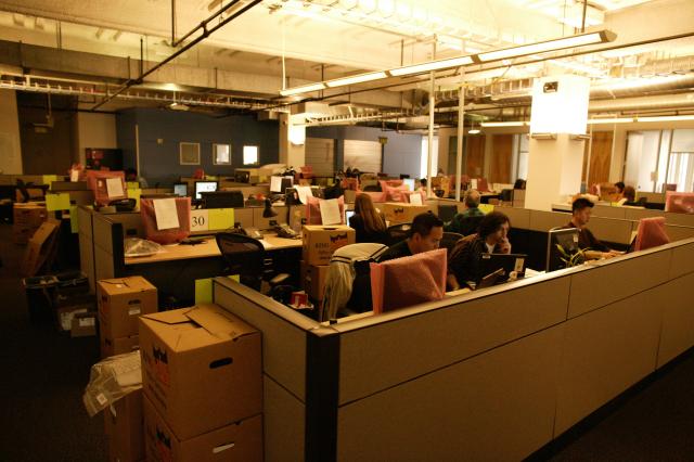 this is an office space that has several people sitting at desks