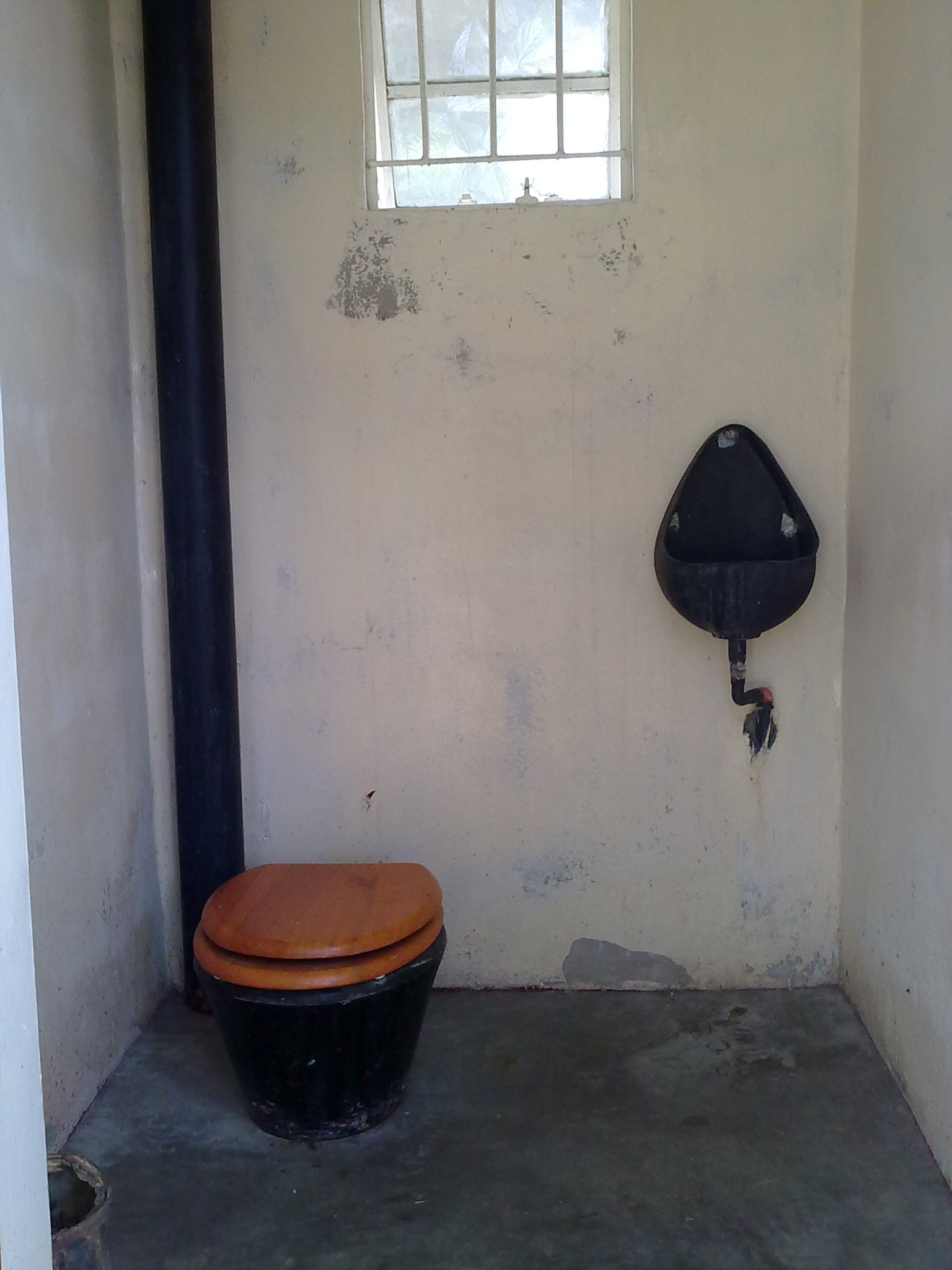 a toilet that is sitting in a small room