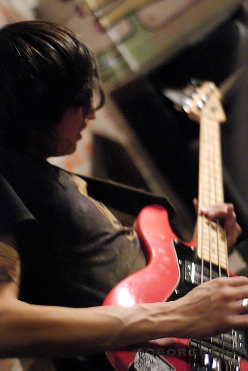 a person plays on a red guitar