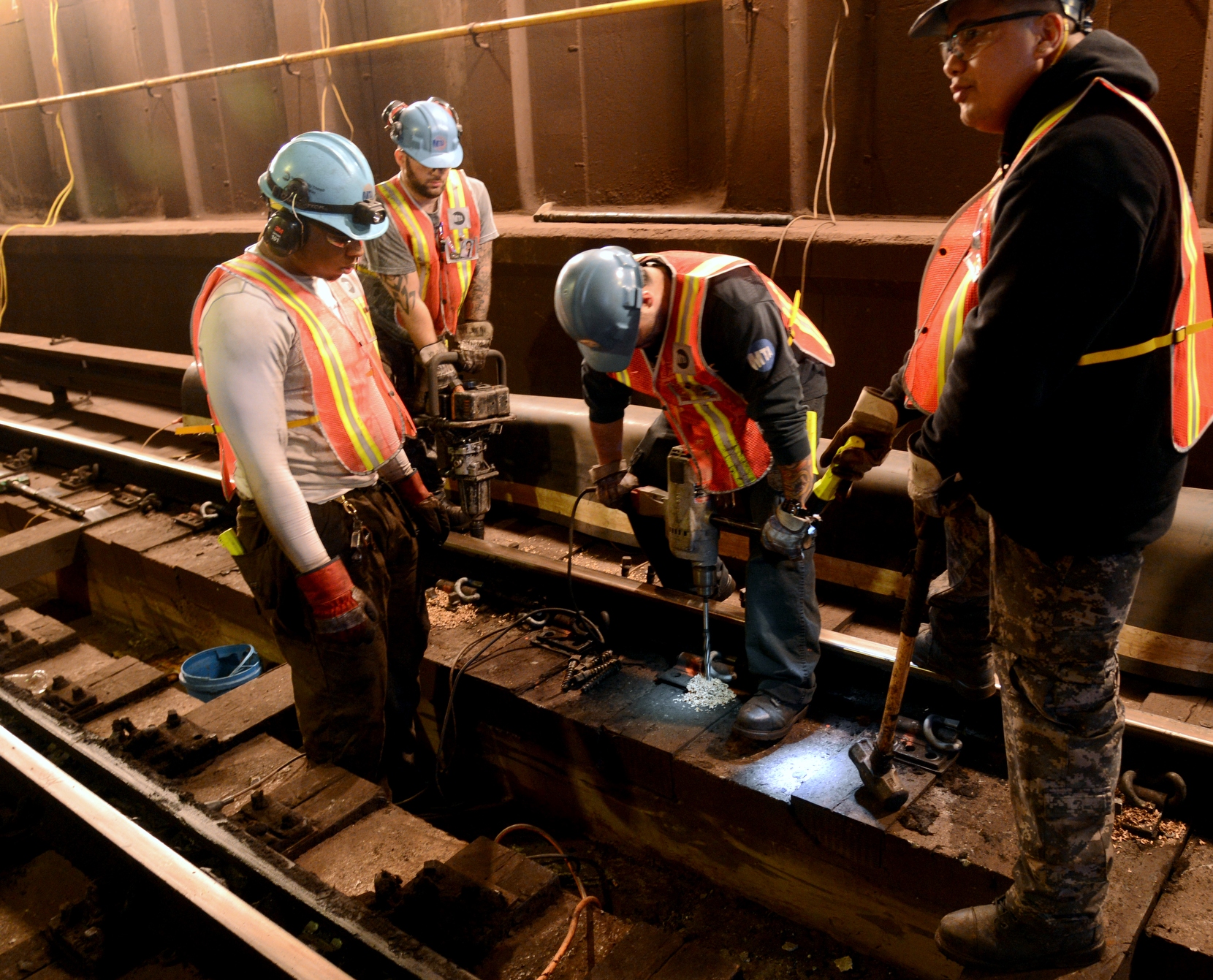 men with safety gear and welding equipment at work