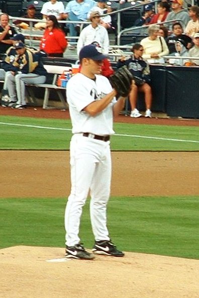 baseball pitcher standing on the mound with crowd watching