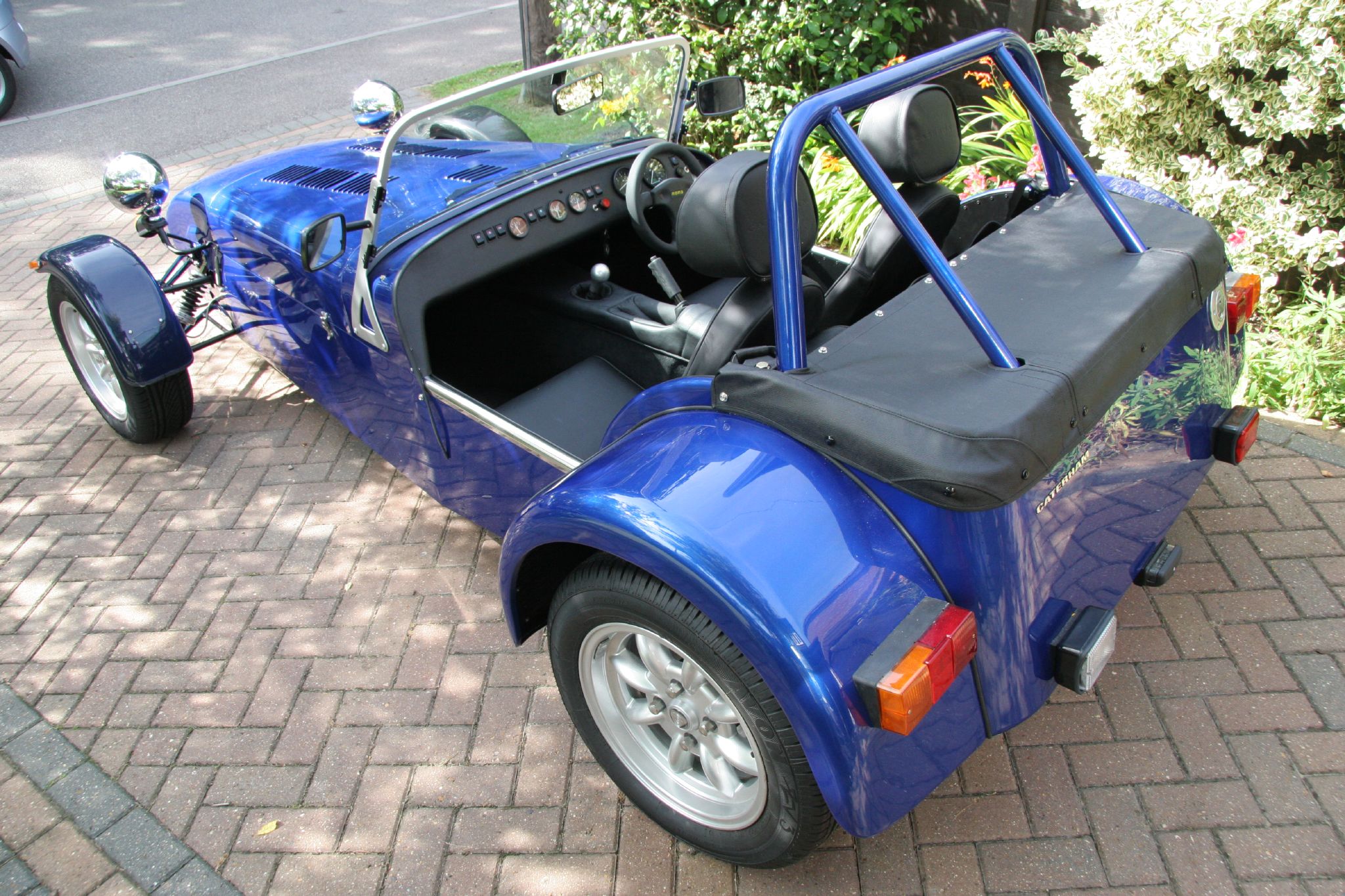 a blue and black motorcycle with side car parked