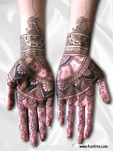 two hands decorated with hendi designs for a wedding