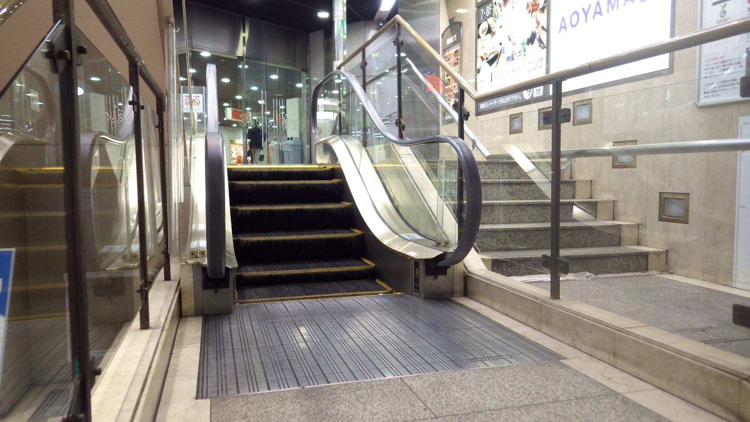 an escalator that leads up to a second floor