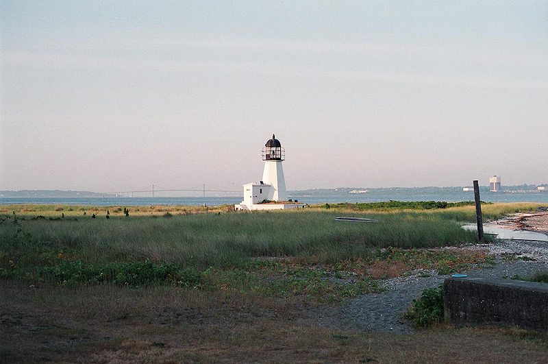 an old lighthouse is near the ocean shore