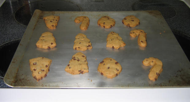 nine chocolate chip cookies baking on top of a cookie pan