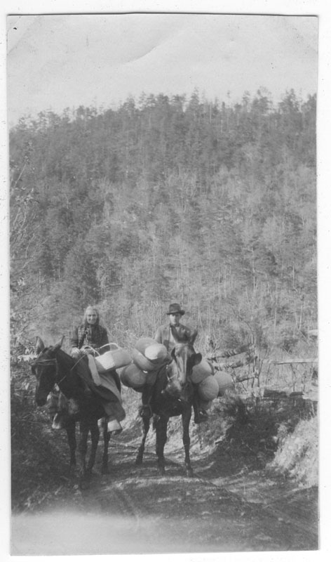 an old pograph of men riding horses on a road