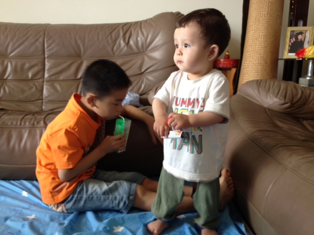 two children are playing on a couch
