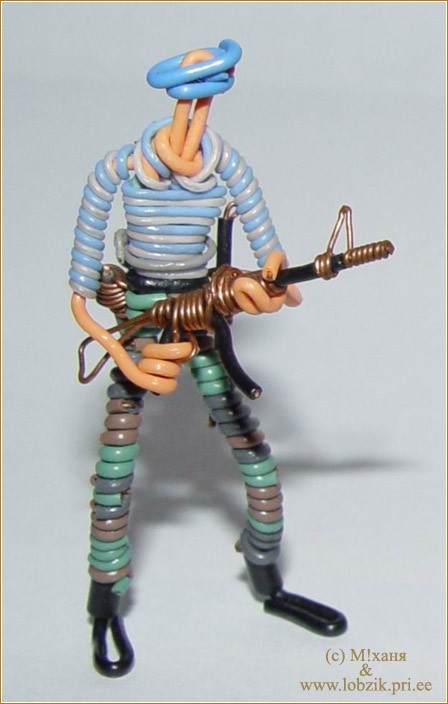 a miniature toy holding a gun and holding it