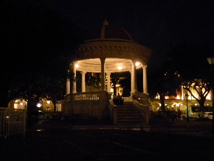 the gazebo at night is lit up with white lights