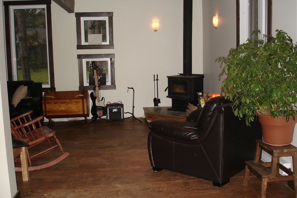 an empty living room with chairs and a fireplace