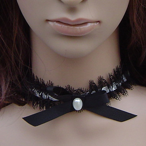 a mannequin wearing an ornate black and white choker with a on