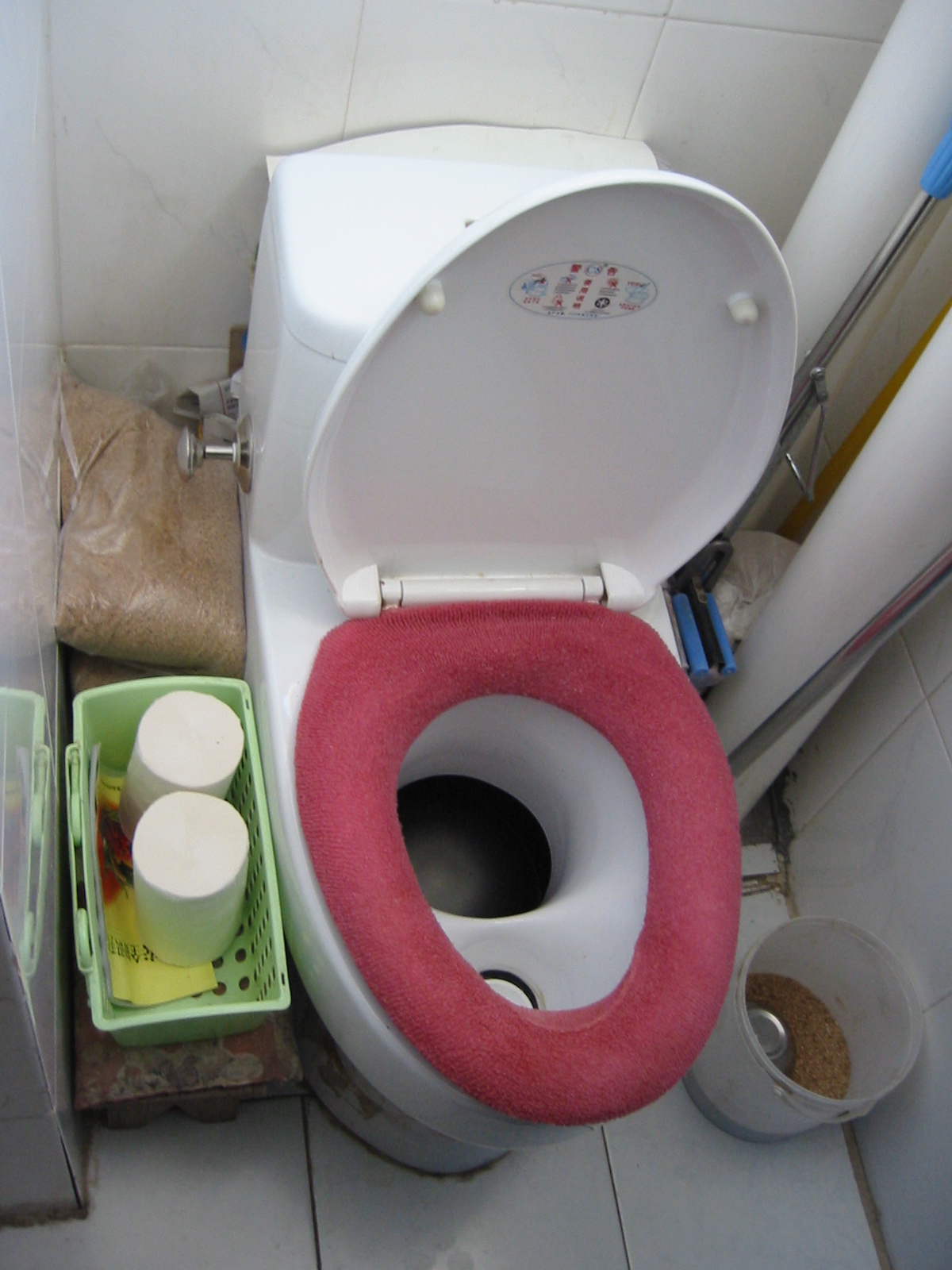 a toilet and a few other items are stacked on the floor