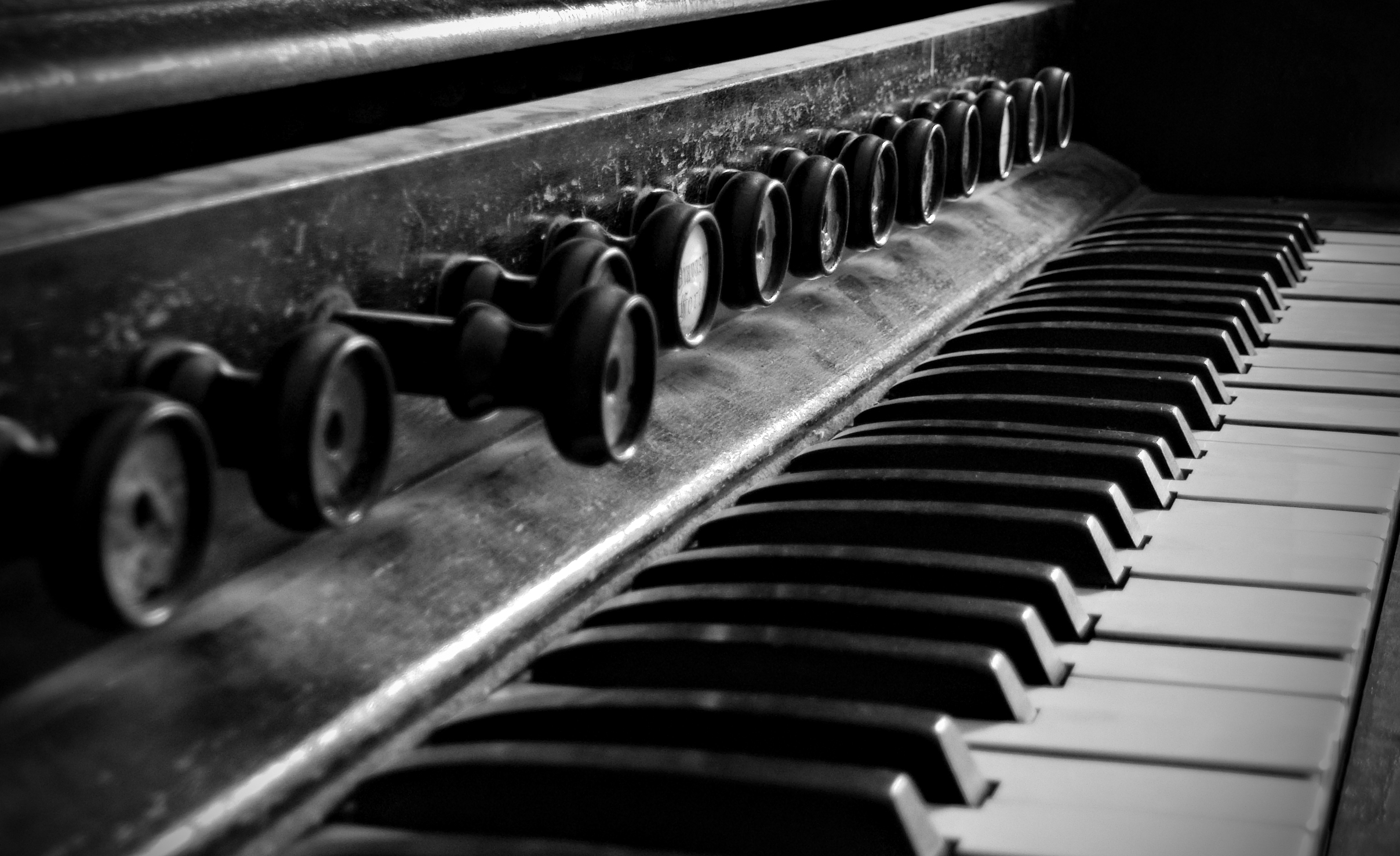 an old black and white piano is resting close up