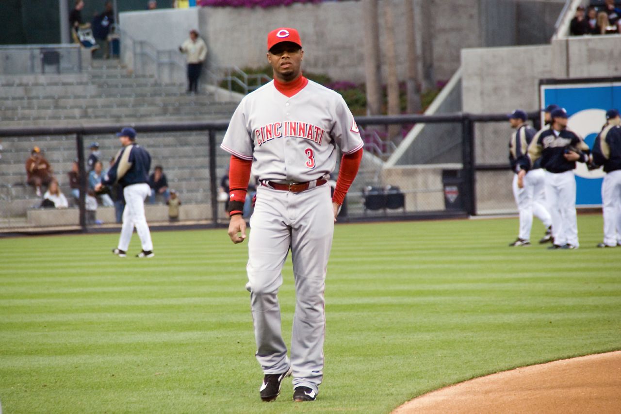 a baseball player walks off the field after his game