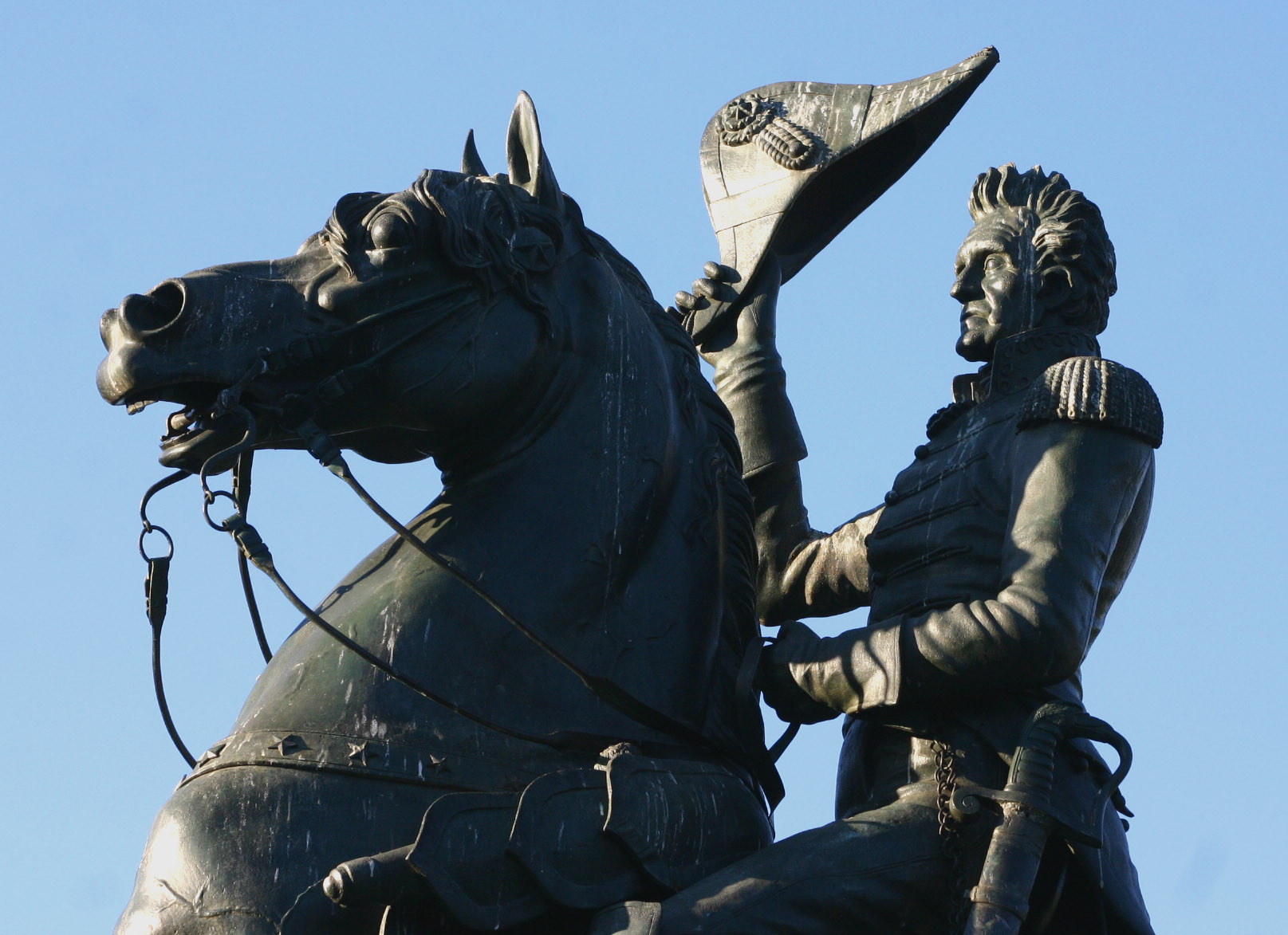 the statue of a man on horseback next to a woman